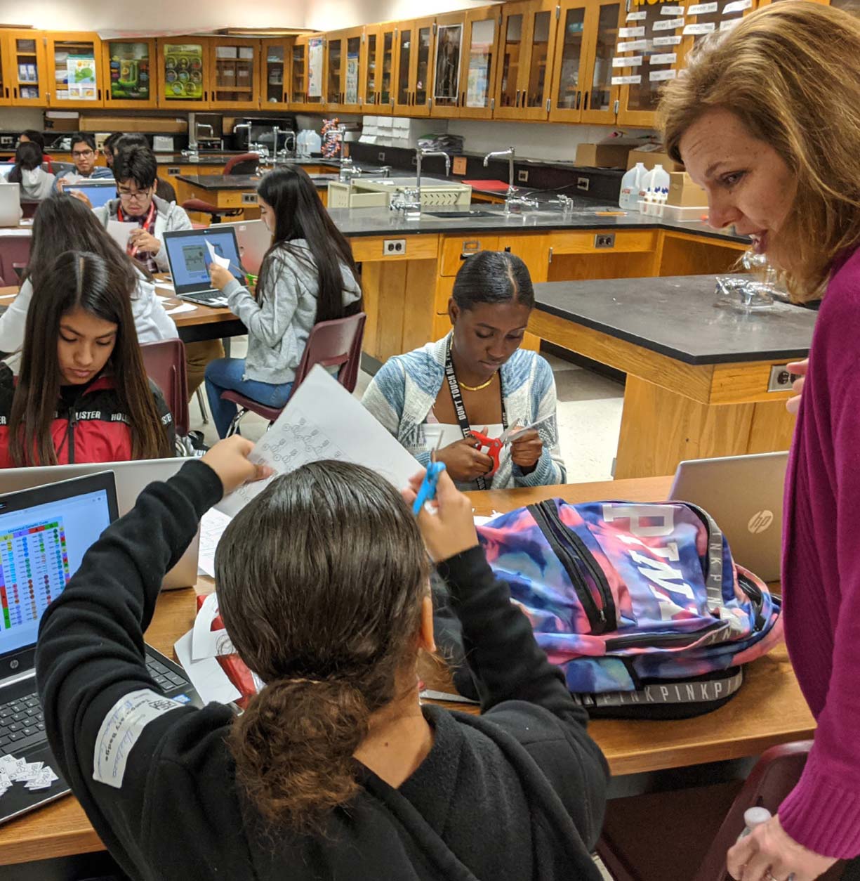 During the Learning Walk hosted for the “Districts for Impact” Five Conditions Learning Cadre, Assistant Superintendent for Middle Schools Marcy Hetzler-Nettles interacts with students from Immokalee High School.